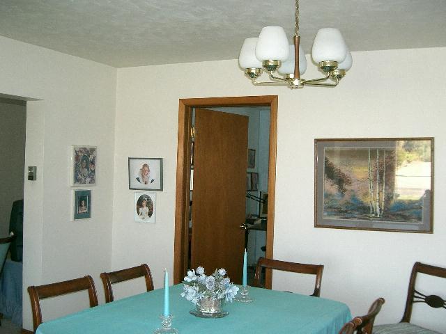 1841 Liberty Road Granger, WA 98932 - Photo 7 of 8 a view of a dining room with furniture a chandelier and wooden floor