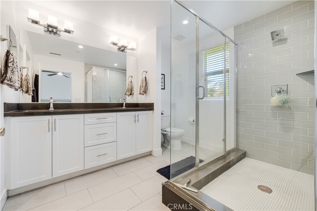 6747 Rhea Court Reseda, CA 91335 - Photo 19 of 26 a bath room with a sink a mirror and a shower