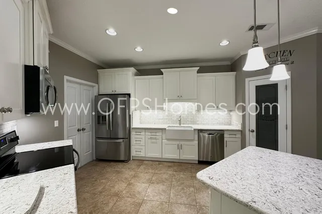 a kitchen with refrigerator and cabinets