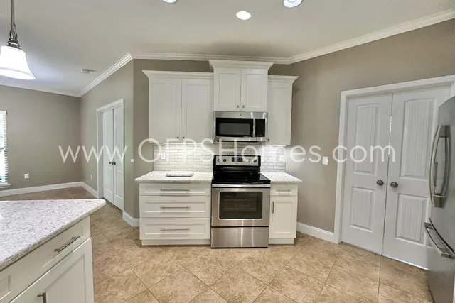 a kitchen with a stove microwave and refrigerator