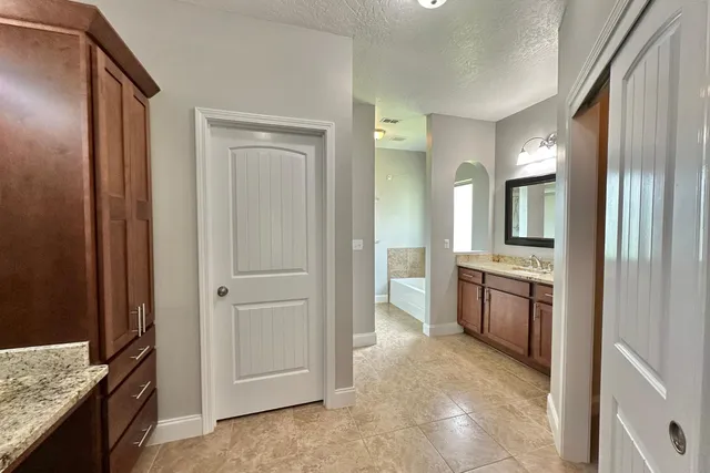 a view of a bathroom with a granite countertop sink and a mirror