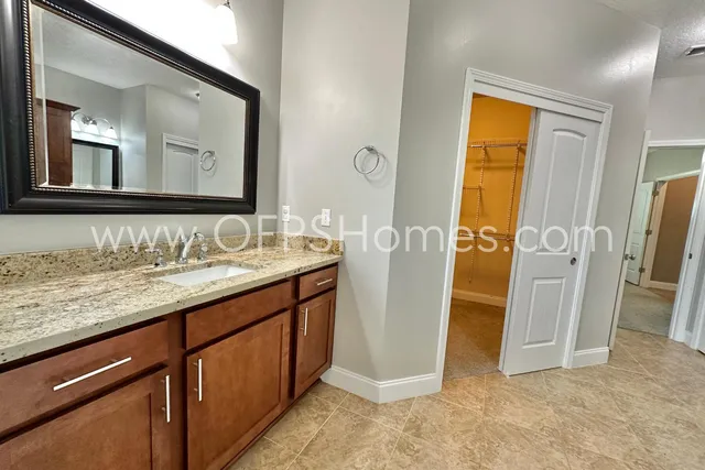 a bathroom with a double vanity sink and a mirror