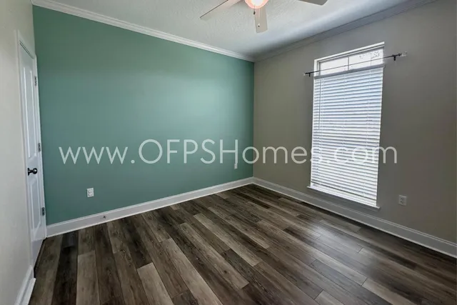 a view of a room with stairs and wooden floor