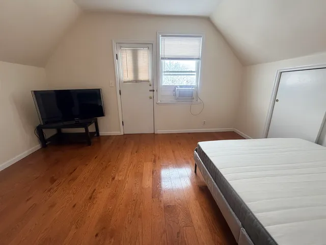 a room with a bed and a flat screen tv