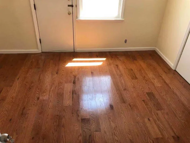 a view of a room with wooden floor
