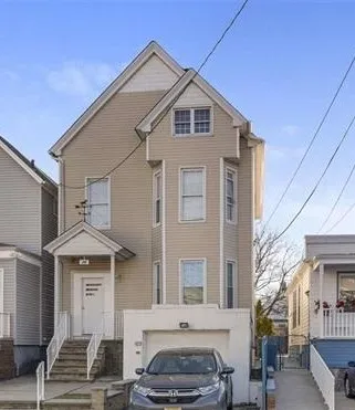 a front view of a house with a street