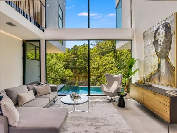 a living room with furniture and a floor to ceiling window