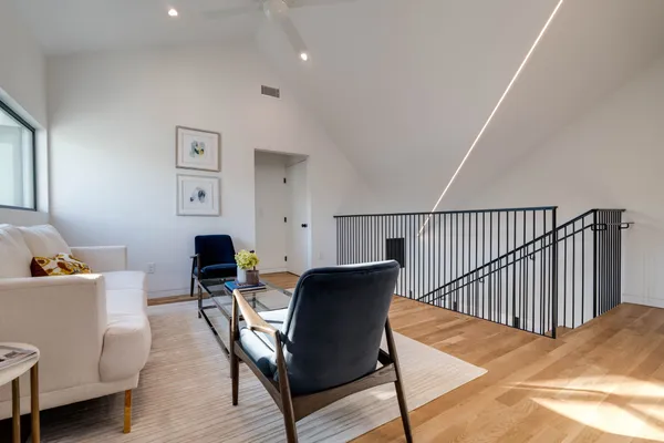 a living room with furniture and a wooden floor