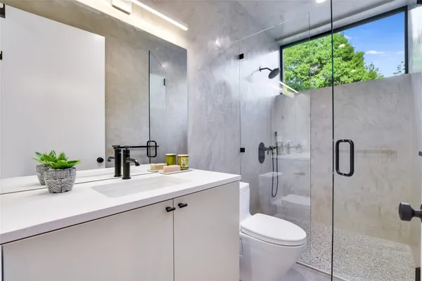 a bathroom with a double vanity sink mirror and shower