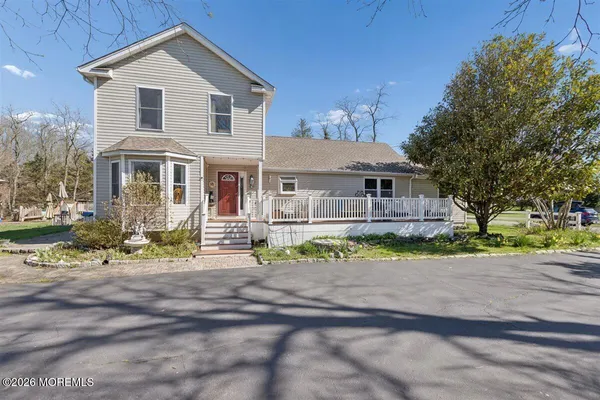 a front view of a house with a yard and a garage
