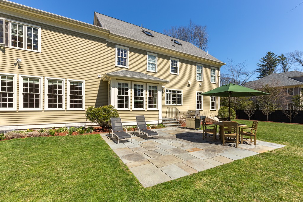 24 Burroughs Road Lexington, MA 02420 - Photo 29 of 30 a view of a house with backyard sitting area and garden