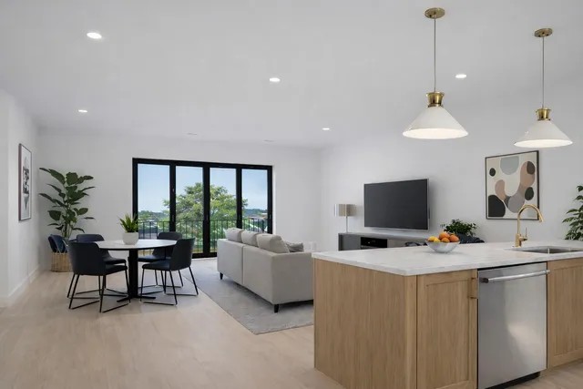 a living room with furniture a window and a flat screen tv