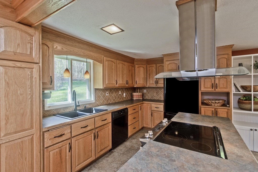 13 Enfield Road Pelham, MA 01002 - Photo 4 of 28 a kitchen with stainless steel appliances a stove sink and cabinets
