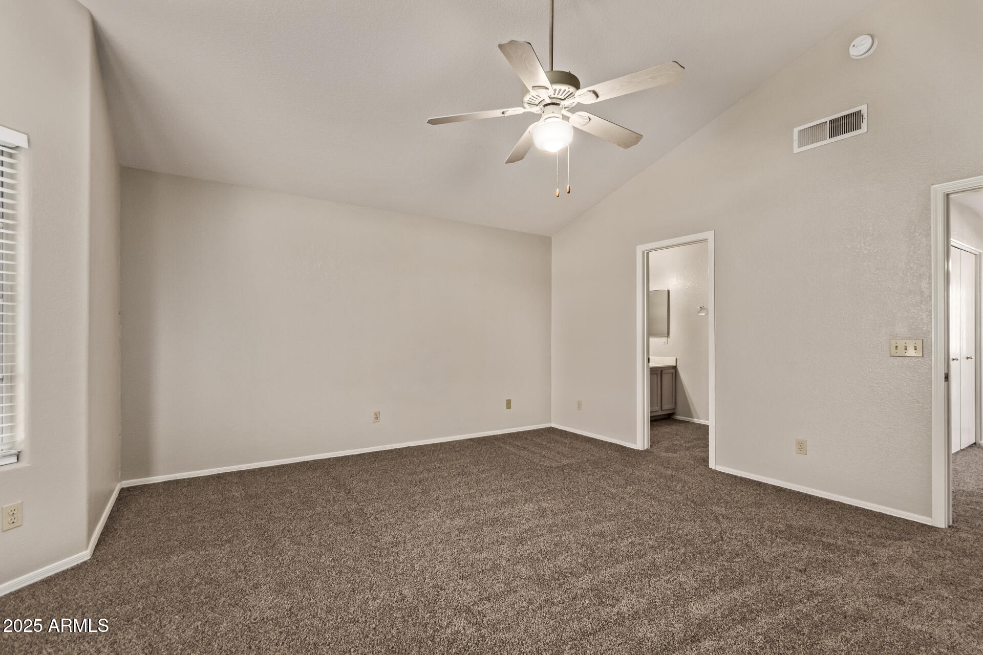 2875 West Highland Street, Unit 1112 Chandler, AZ 85224 - Photo 16 of 33 an empty room with a chandelier fan and windows