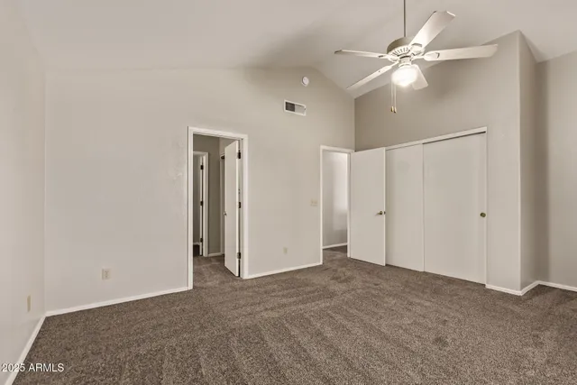 a view of an empty room with a ceiling fan