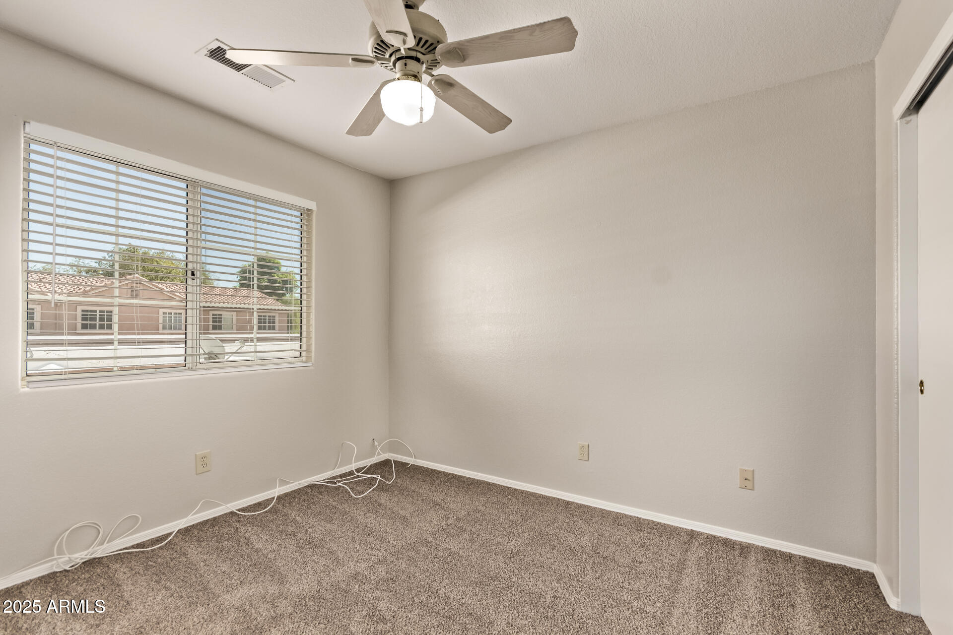 2875 West Highland Street, Unit 1112 Chandler, AZ 85224 - Photo 20 of 33 an empty room with a window and a fan