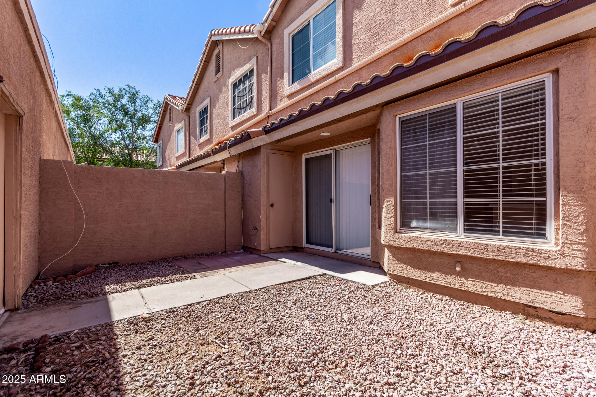 2875 West Highland Street, Unit 1112 Chandler, AZ 85224 - Photo 28 of 33 a view of a house with a door and wooden fence