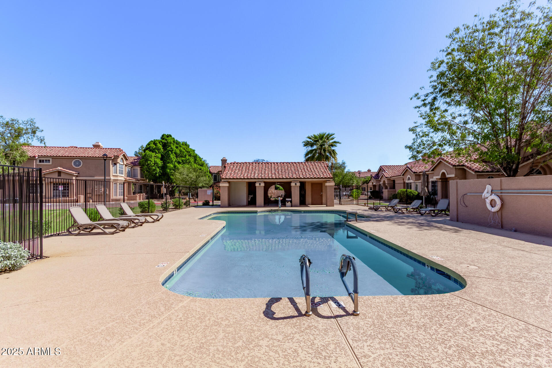 2875 West Highland Street, Unit 1112 Chandler, AZ 85224 - Photo 31 of 33 a view of a swimming pool with lawn chairs