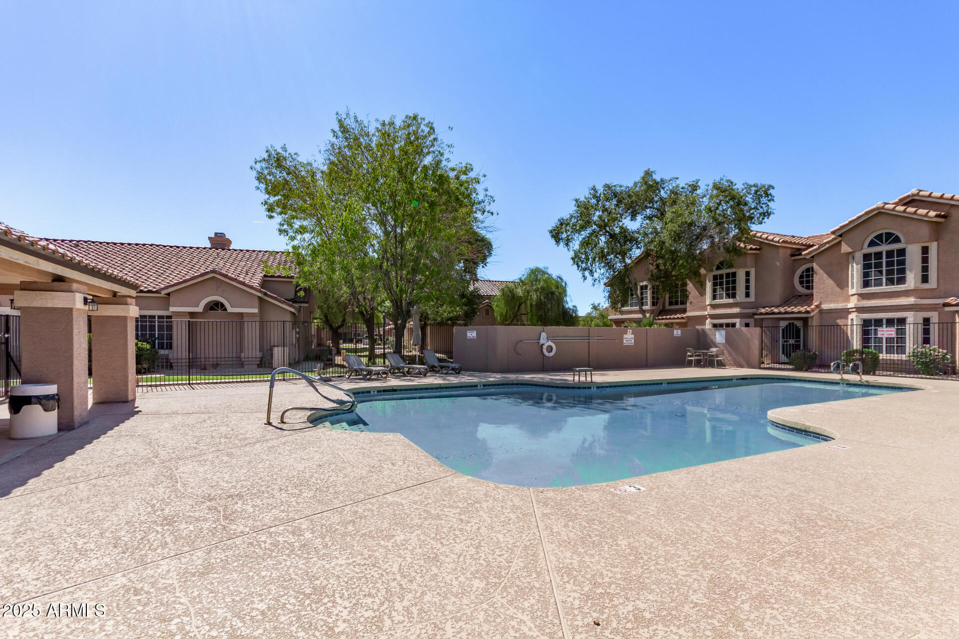 2875 West Highland Street, Unit 1112 Chandler, AZ 85224 - Photo 33 of 33 a view of a swimming pool with lounge chair