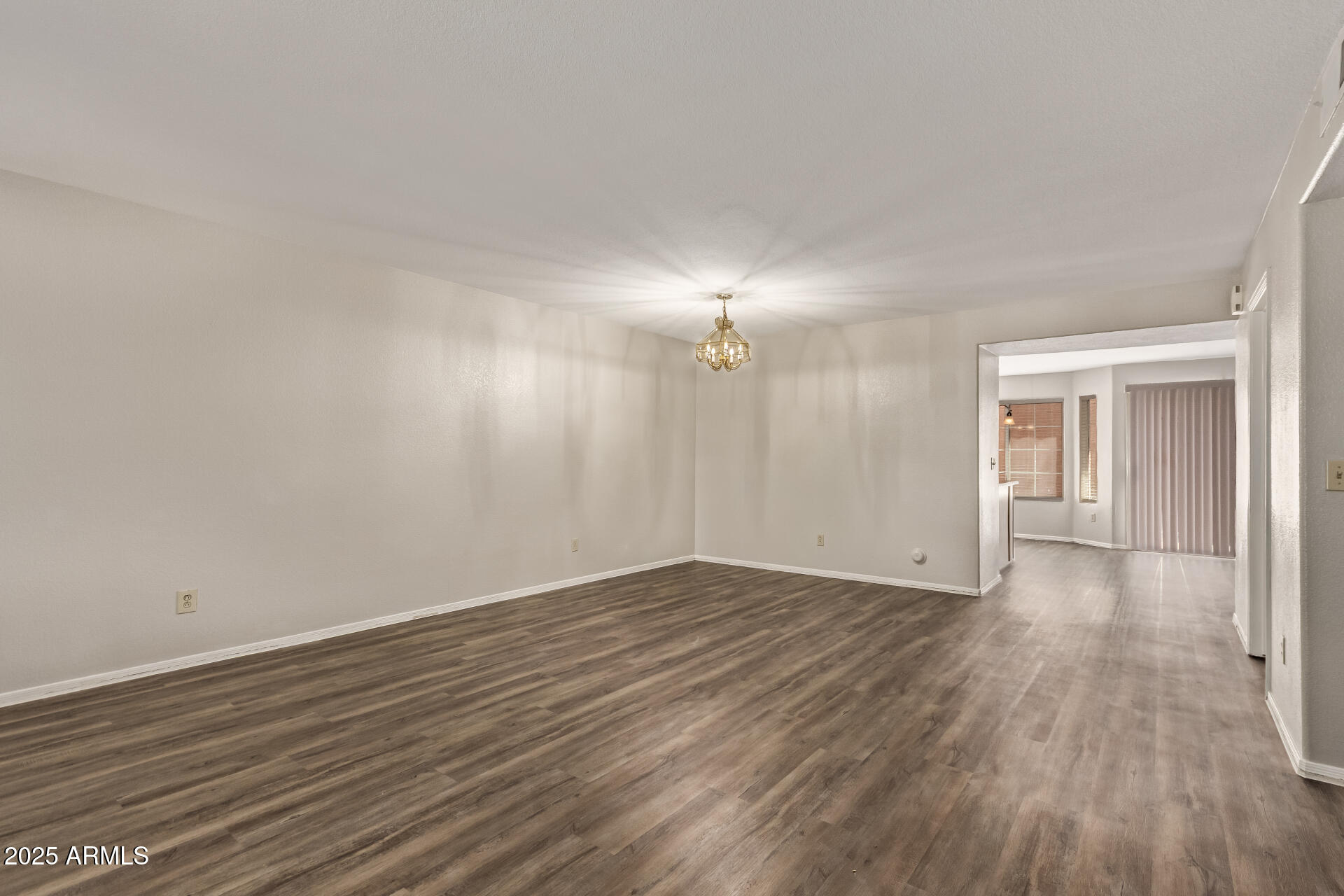 2875 West Highland Street, Unit 1112 Chandler, AZ 85224 - Photo 4 of 33 a view of an empty room with wooden floor