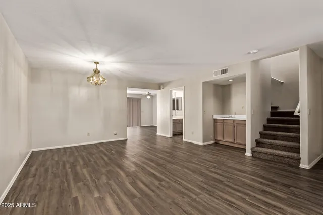 a view of a room with wooden floor and stairs