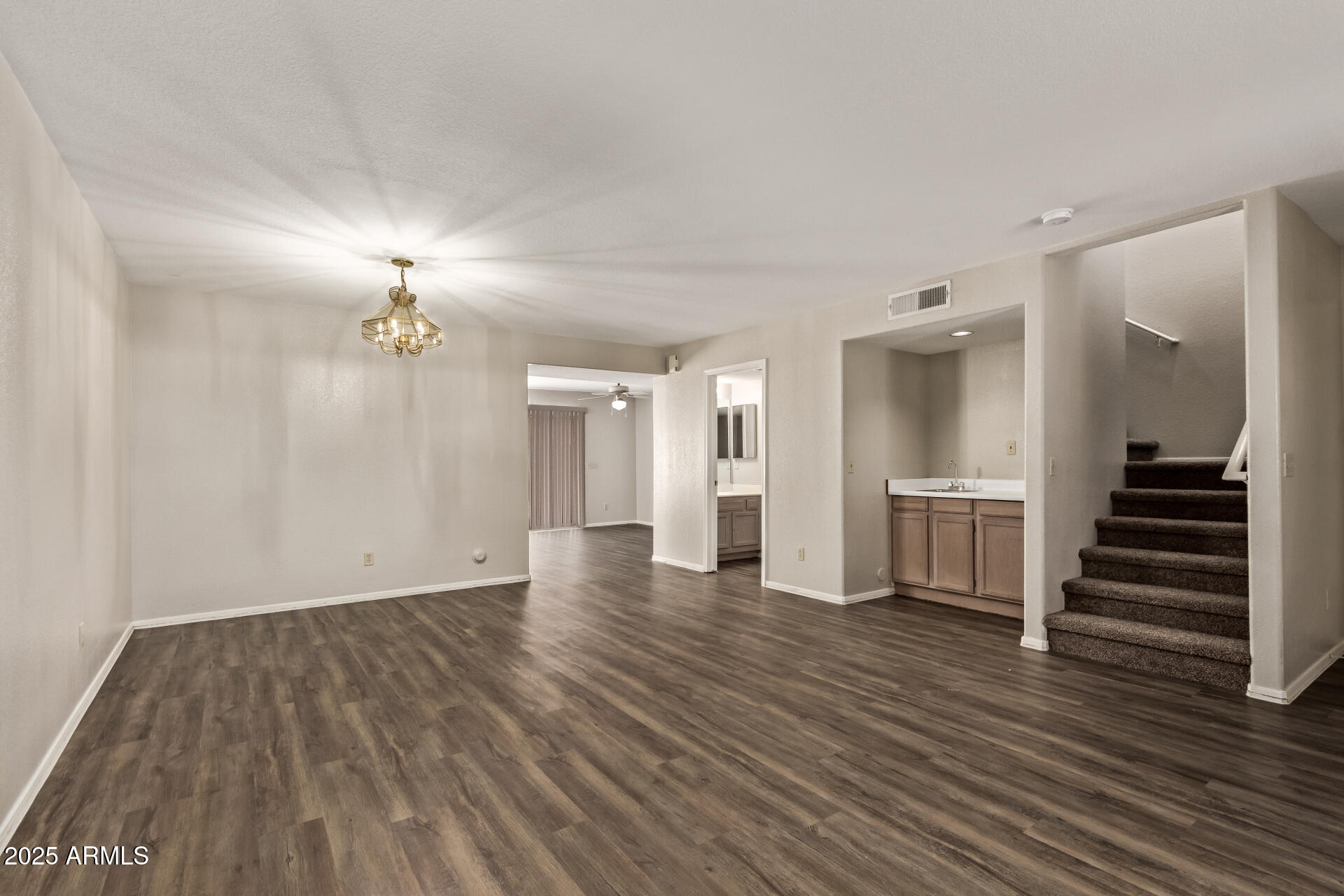 2875 West Highland Street, Unit 1112 Chandler, AZ 85224 - Photo 5 of 33 a view of a room with wooden floor and stairs