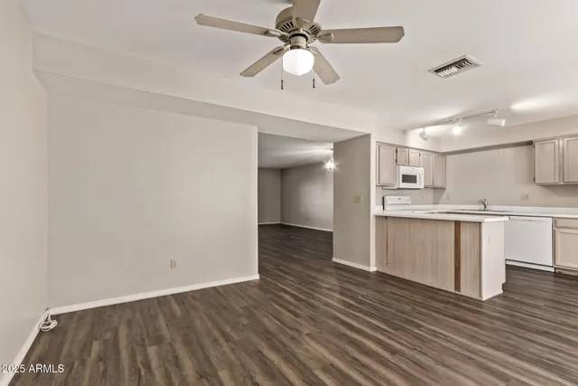 a view of kitchen with granite countertop cabinets and wooden floor