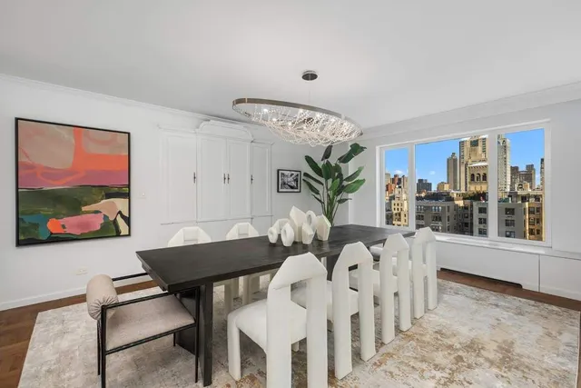 a living room with furniture and a view of kitchen