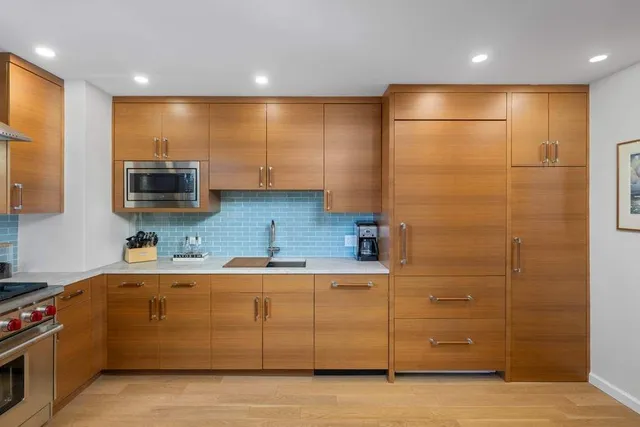 a large kitchen with a table and chairs in it