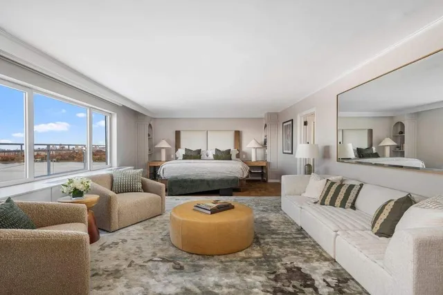 a living room with furniture and a lamp