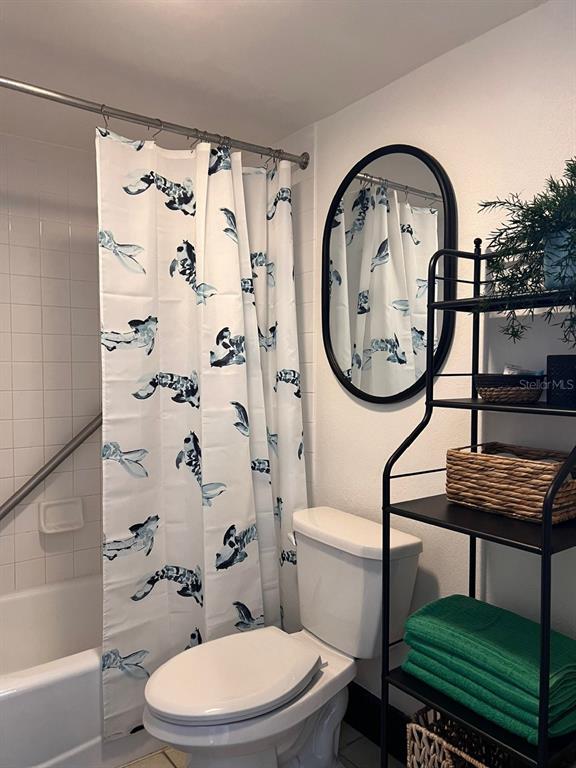 611 Destiny Drive, Unit 115 Ruskin, FL 33570 - Photo 12 of 28 a bathroom with a toilet a sink and a shower