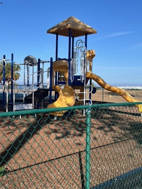 611 Destiny Drive, Unit 115 Ruskin, FL 33570 - Photo 20 of 28 a front view of a house with yard and patio