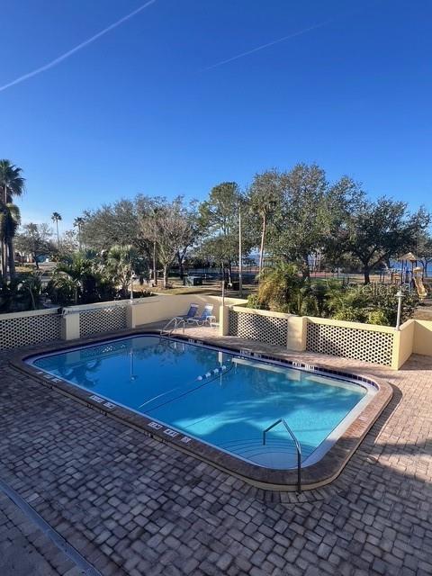 611 Destiny Drive, Unit 115 Ruskin, FL 33570 - Photo 22 of 28 a view of a swimming pool with an outdoor space and seating