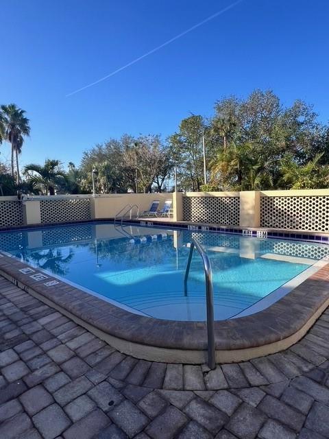 611 Destiny Drive, Unit 115 Ruskin, FL 33570 - Photo 24 of 28 a view of a swimming pool with a patio