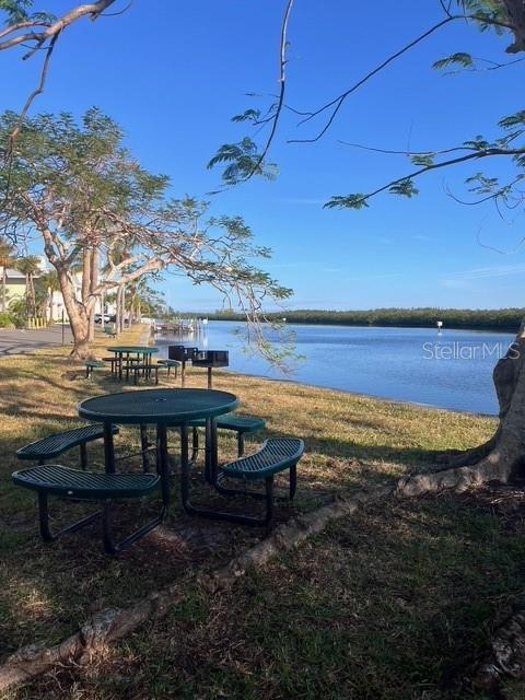611 Destiny Drive, Unit 115 Ruskin, FL 33570 - Photo 25 of 28 a view of a swimming pool with chair and table