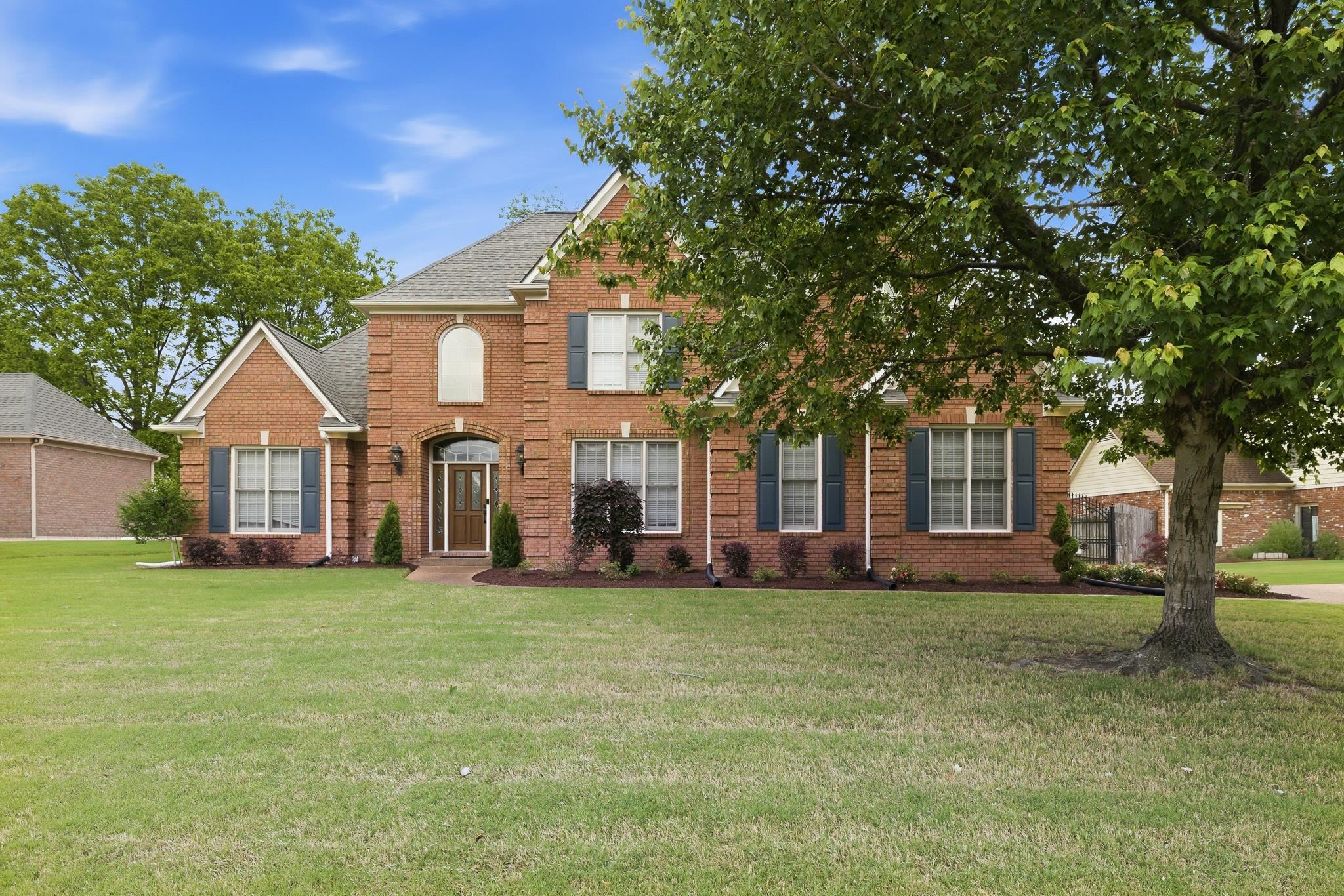 1348 Colbert Cove Collierville, TN 38017 - Photo 1 of 34 a view of a white house in front of a big yard with large trees
