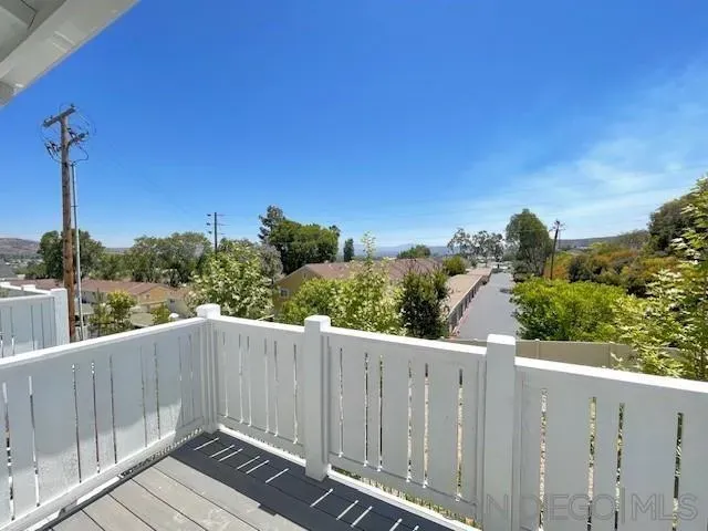 a view of a balcony with wooden fence