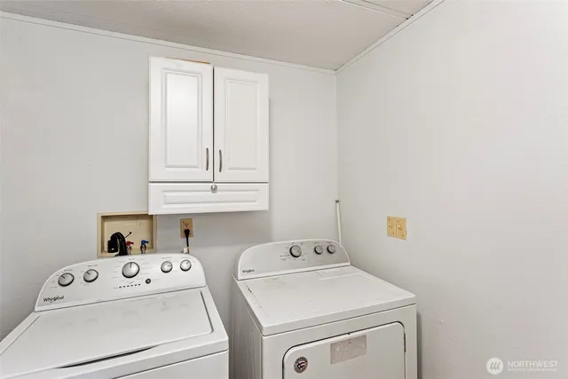 a view of storage and utility room with washer and dryer