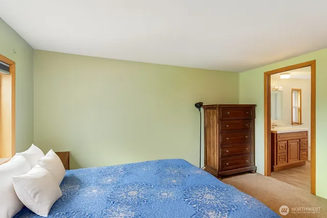 a bedroom with a bed and a dresser