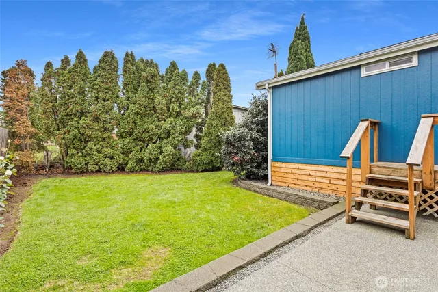 a view of a pool with a backyard and trees