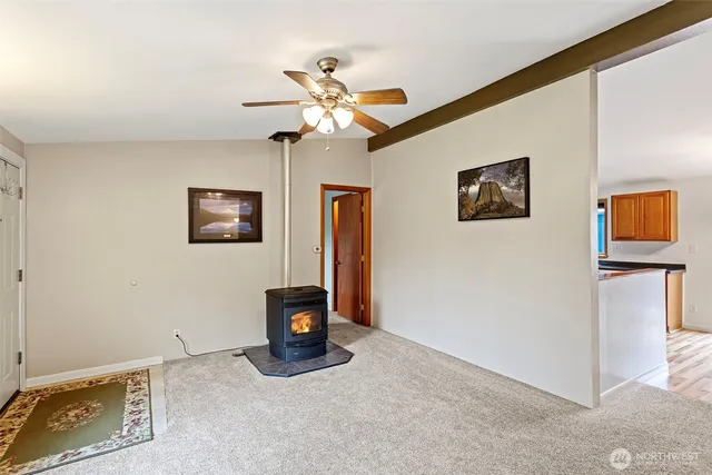a view of a livingroom with a chandelier fan and a workspace