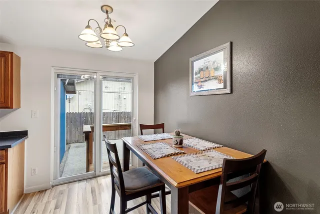 a view of a dining room with a table and chairs