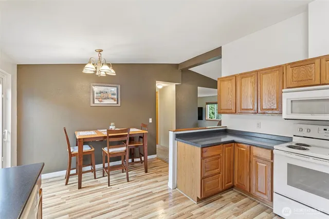 a kitchen with a table chairs and microwave