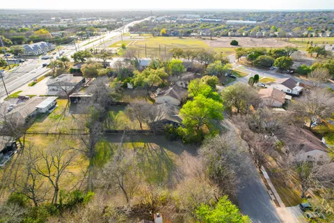 an aerial view of residential houses with outdoor space and swimming pool