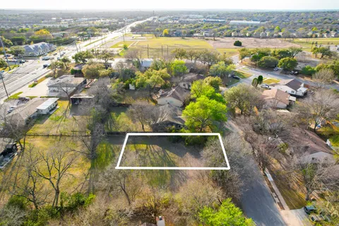an aerial view of residential houses with outdoor space and swimming pool