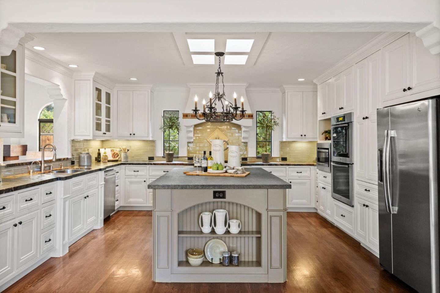 503 Arlington Road Redwood City, CA 94062 - Photo 11 of 48 a kitchen with kitchen island granite countertop a center island a sink stainless steel appliances and cabinets