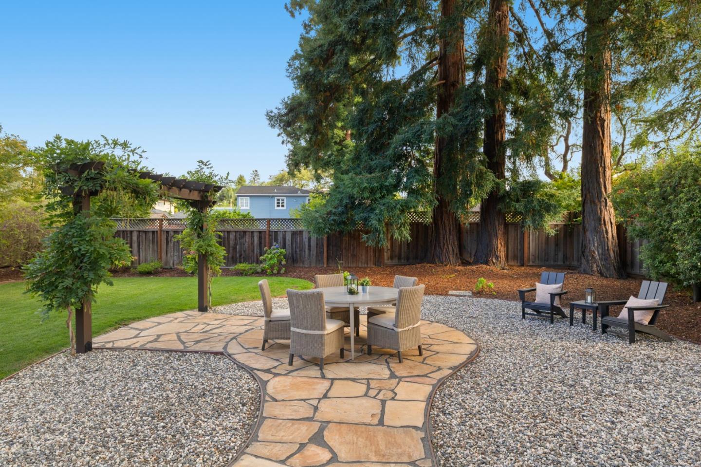 503 Arlington Road Redwood City, CA 94062 - Photo 39 of 48 a view of a patio with table and chairs potted plants and tree