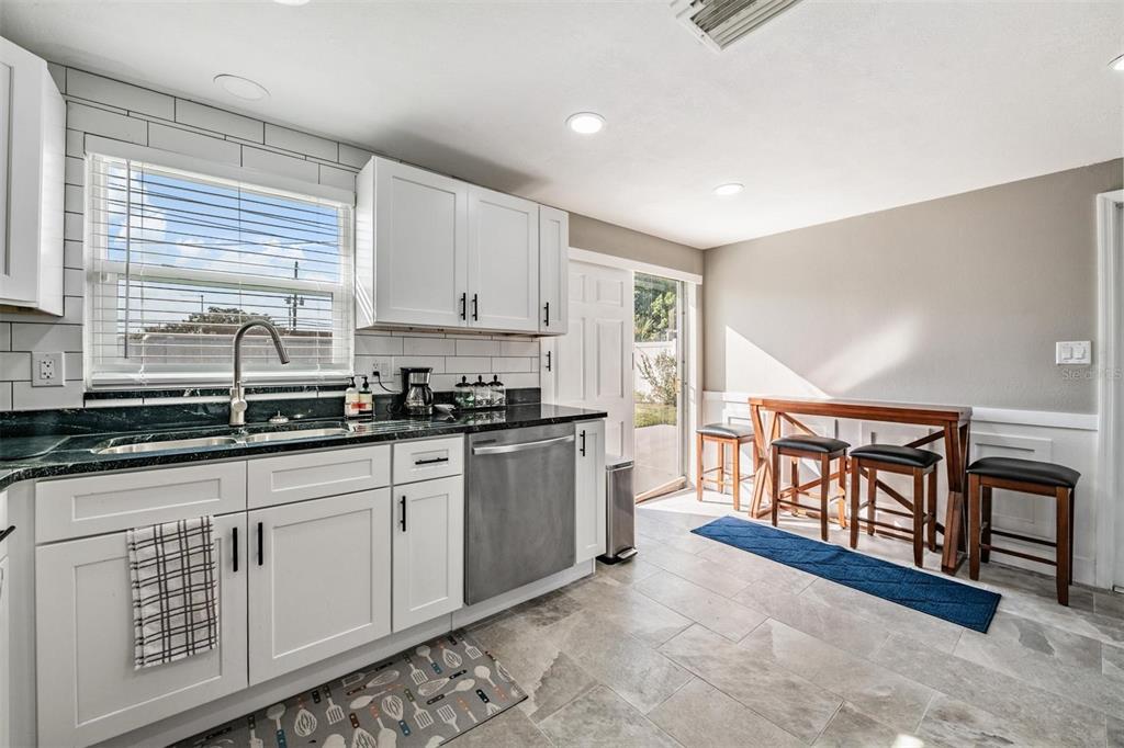 4626 Abdella Lane Holiday, FL 34690 - Photo 34 of 34 a kitchen with stainless steel appliances granite countertop a stove a sink and a microwave