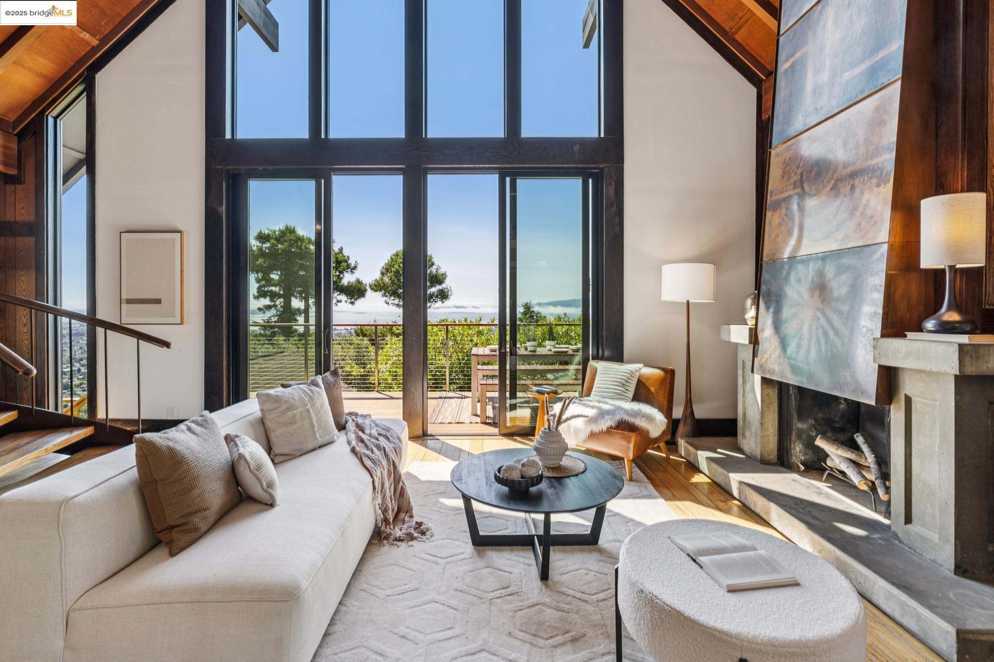 a living room with fireplace furniture and a floor to ceiling window