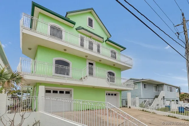 a kitchen with stainless steel appliances wooden floor dining table and chairs